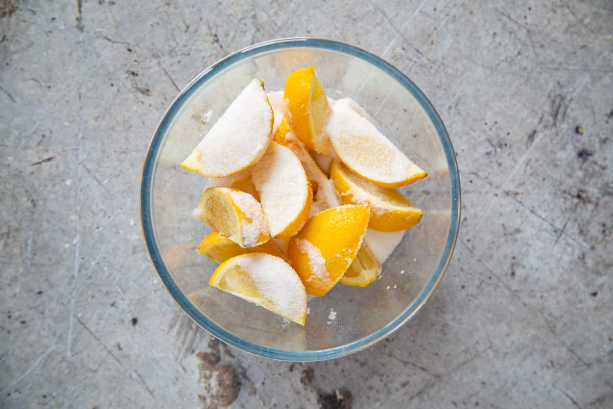 The lemons covered in salt in a bowl.