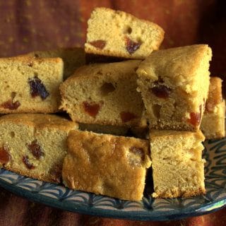 Vegan one step Golden Syrup and plum cake. Squares of golden cake studded with jewel like pieces of dried plum.