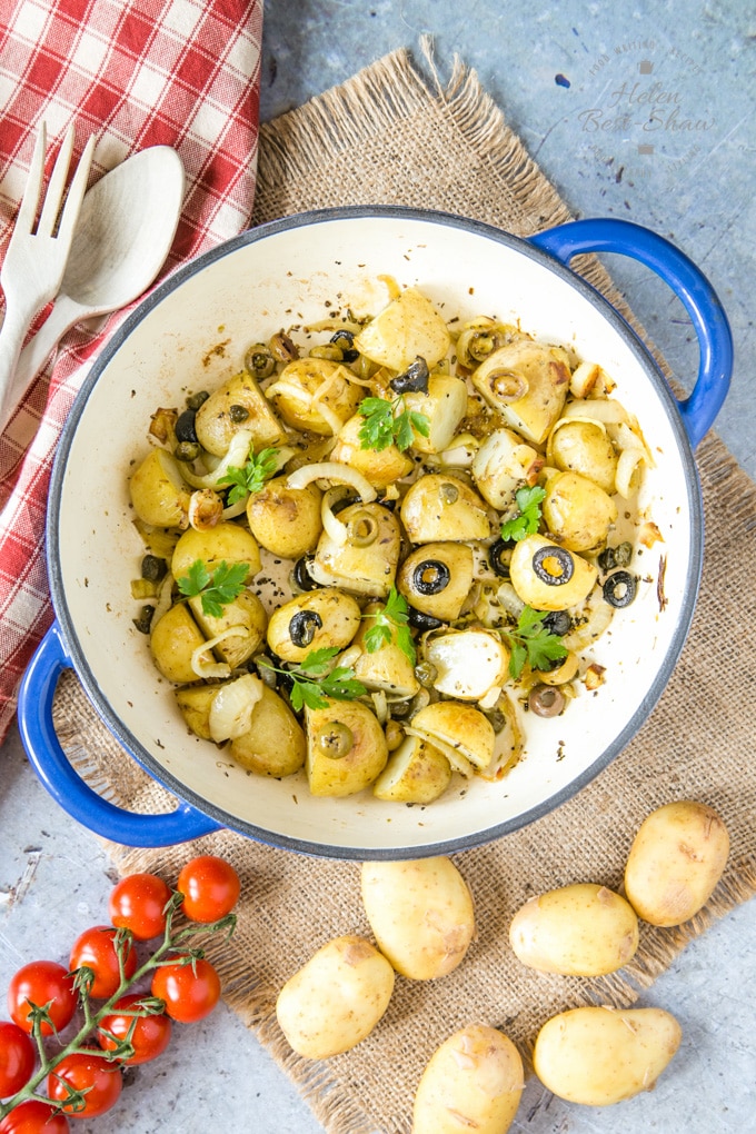 A dish of roasted new potatoes with capers and olives