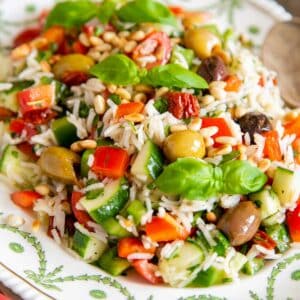 A close up view of Italian rice salad, white rice packed with vibrant vegetables and herbs.