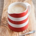 A red and white striped jug of power blender custard