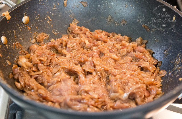 a pan of golden brown sticky caramelized onions which have been cooking for over an hour