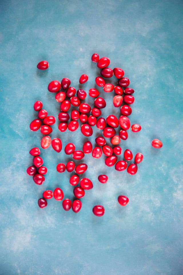 Cranberries on a blue green marble background