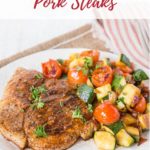 Plate of Southern spiced pork steaks with a side of vegetables