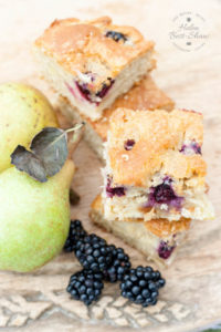 Enjoy this blackberry and pear traybake and use up unripe windfall fruit; it's perfect for picnics.