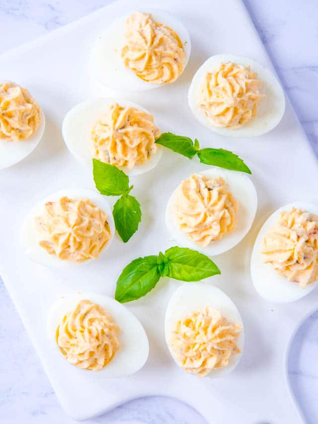 Cheesy jalapeño deviled eggs make a great snack or first course, and deserve to be seen a lot more often than just at parties. They're so easy to make, too! 