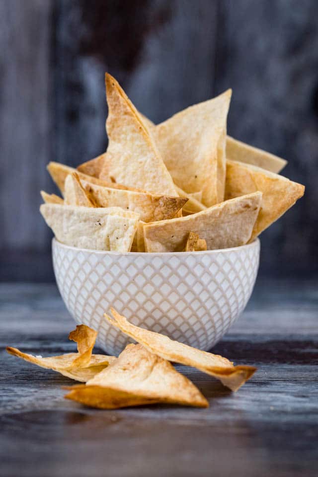 Crispy baked homemade tortilla chips are easy to make from wraps, perfect for your favourite dip and so much more healthy than the packet version! 