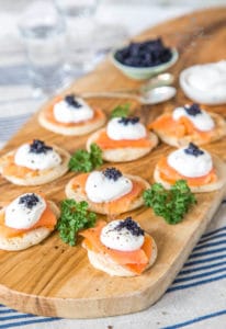 Rich and savoury buckwheat sourdough blinis, topped with smoked salmon, sour cream and fish roe