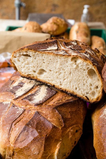 Large loaf of bread cut open at the market Ventalló Catalonia