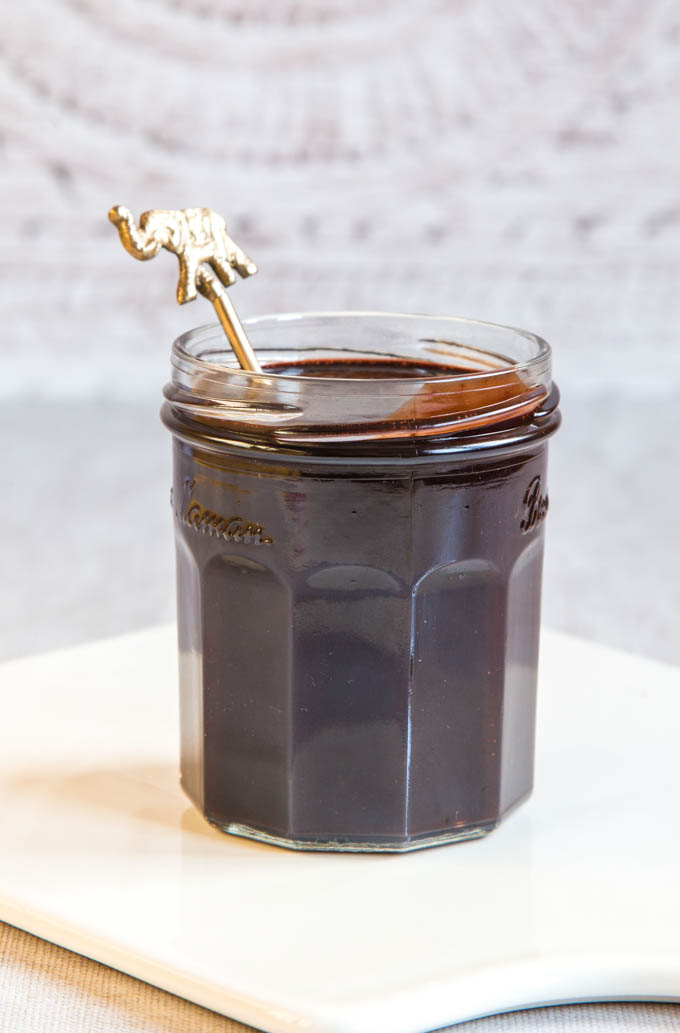 a jar of rich, dark two ingredient vegan chocolate sauce
