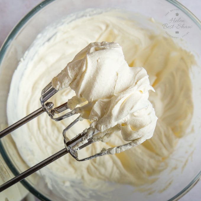 Whipped cream on two whisks.