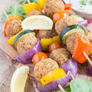 A close up of four falafel and Mediterranean vegetable kebabs