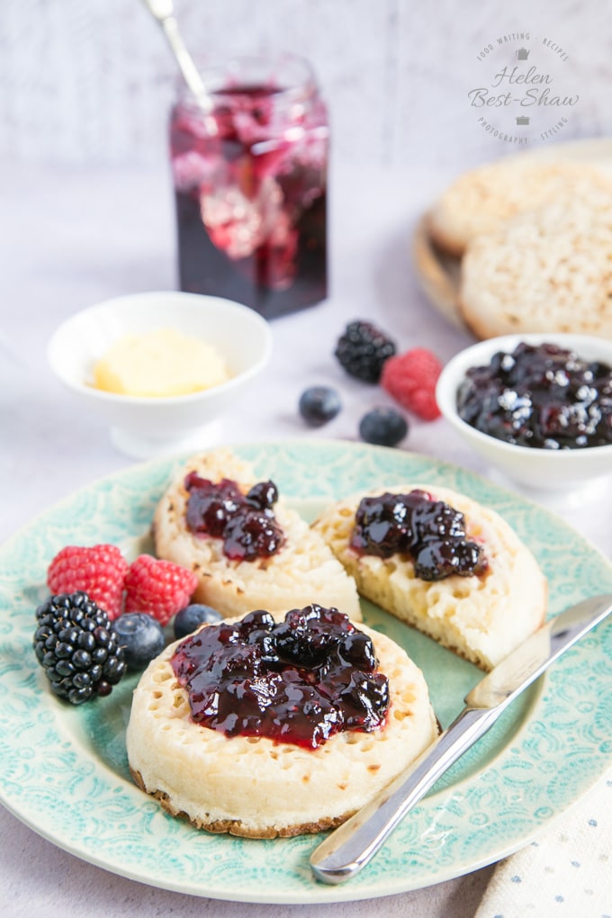 Two crumpets spread with richly flavoured dark purple mixed berry jam