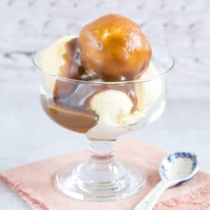 A glass bowl with ice cream covered with my easy hot fudge sauce.