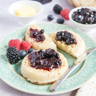 Two crumpets spread with richly flaovured dark purple mixed berry jam