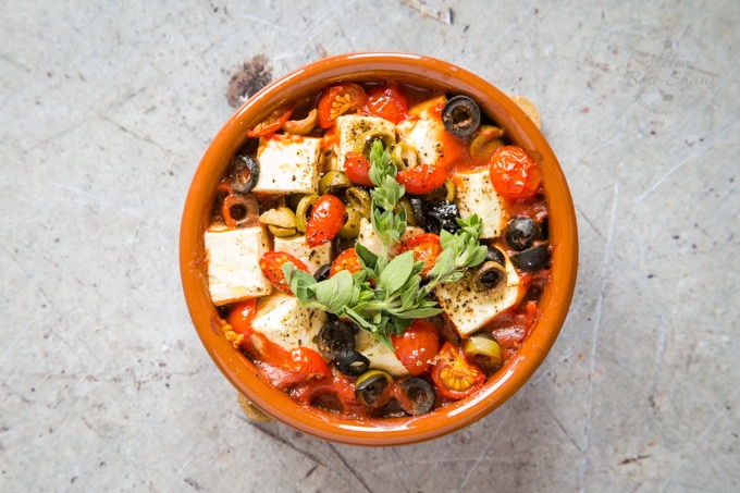 Cooked baked feta, garnished with fresh herbs.
