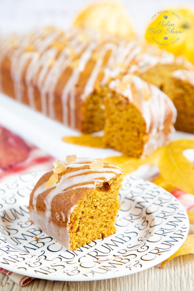 A square of pumpkin spice cake with a drizzled topping.