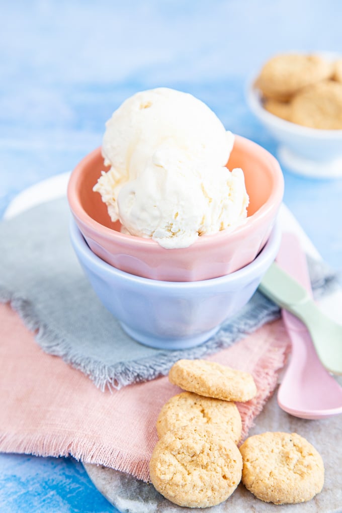 A stack of two pastel colored bowls holding no churn maple ice cream.
