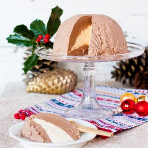 Ice cream bombe on glass stand with holly