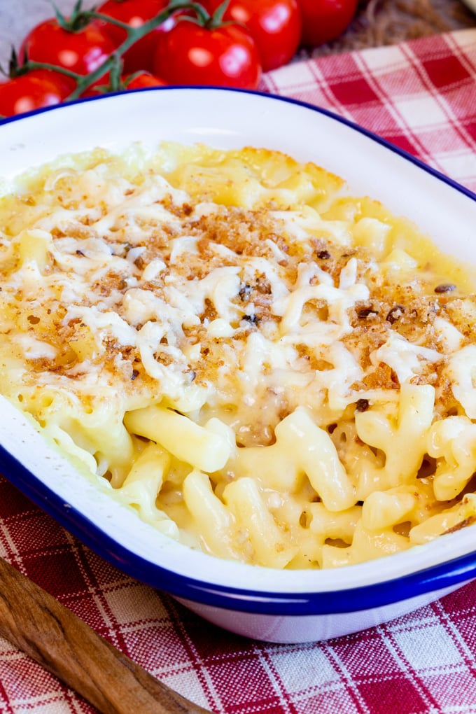 A close up of a dish of easy macaroni and cheese with a crispy top.