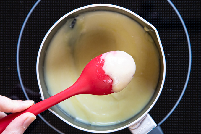 Cheese sauce coating the back of a spoon