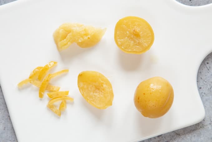 Preparing preserved lemons - scraping out the flesh, and cutting the skin into narrow slices.