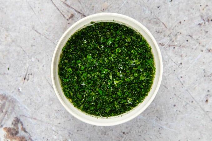 Finished mint sauce in a white ramekin dish, ready to serve, viewed from above.