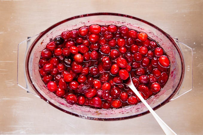 Cooked bright red cranberries, ready to serve with a spoon onto roast turkey or ham.