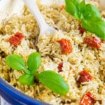A close up of a spoonfull of Italian rice being taken from a dish.
