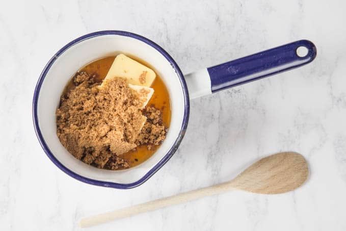 a saucepan with butter, honey and brown sugar