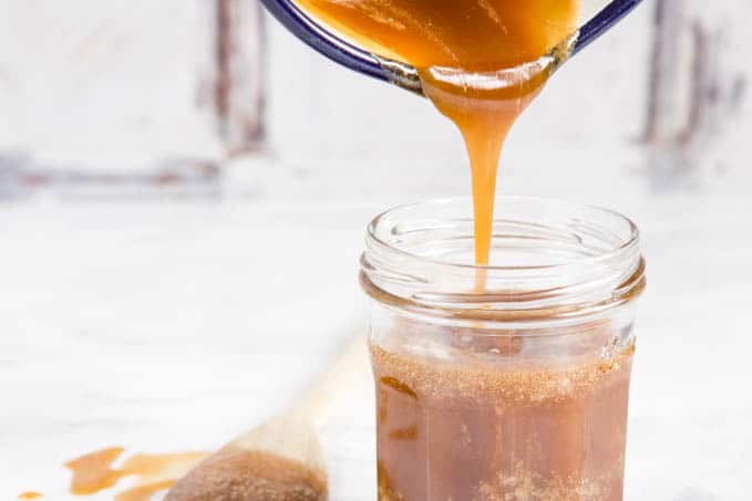 hot honey sauce being poured into a jar