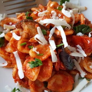A top down picture of tomato red pasta with Nduja and aubergine sauce.