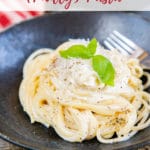 Bowl of creamy philly pasta with a basil sprig