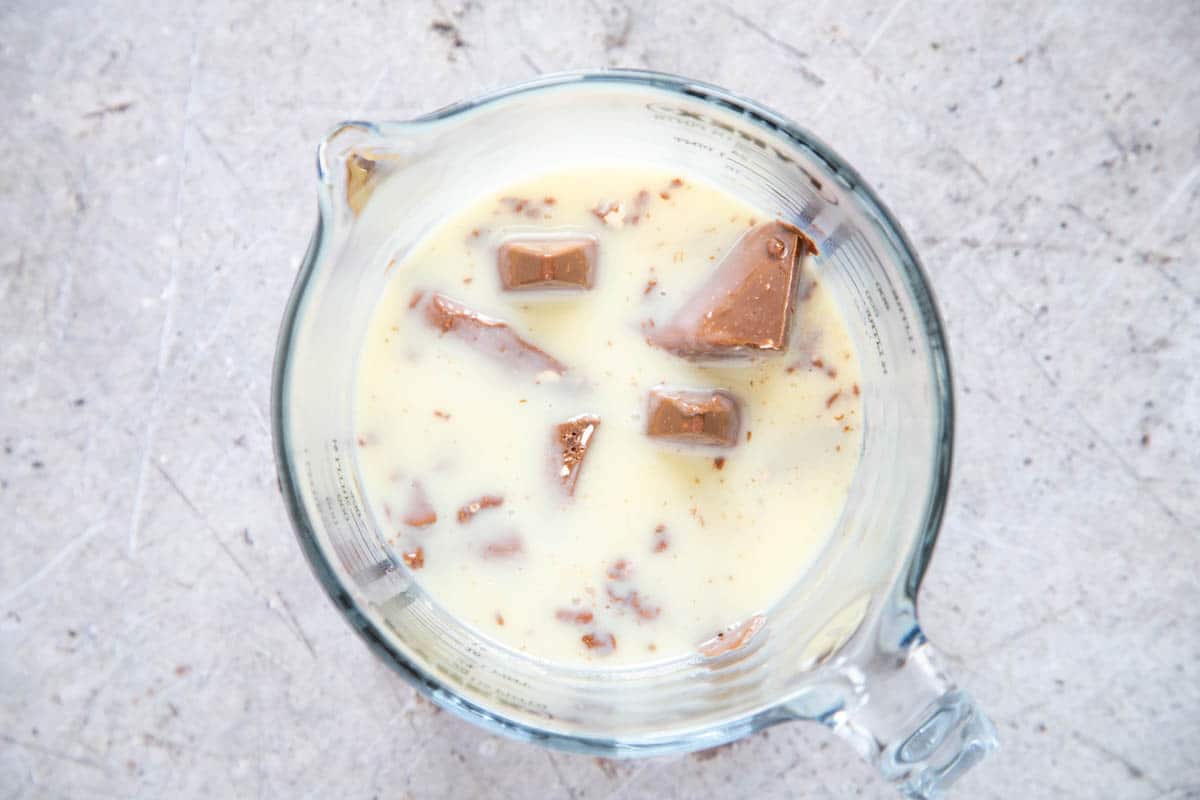 Microwave melted Toblerone and condensed milk in a glass jug, taken from above.