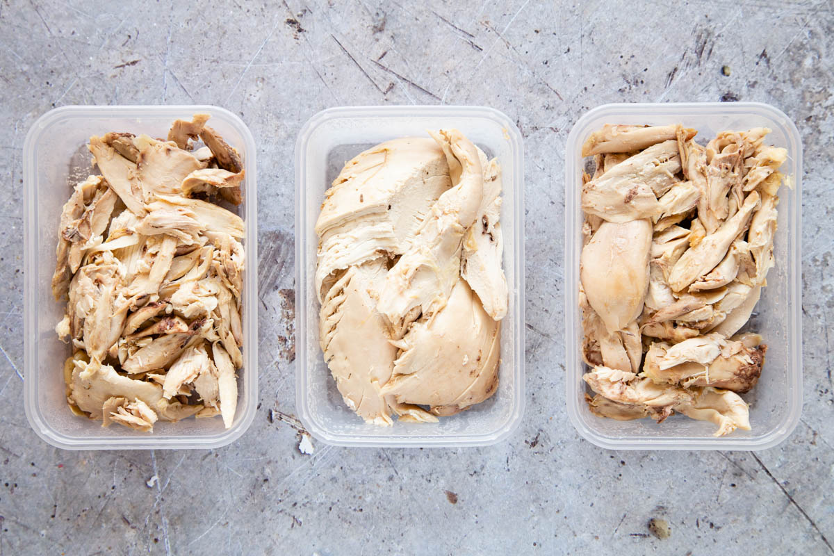 Leftover roast chicken packed into three plastic take-away boxes, ready to freeze.