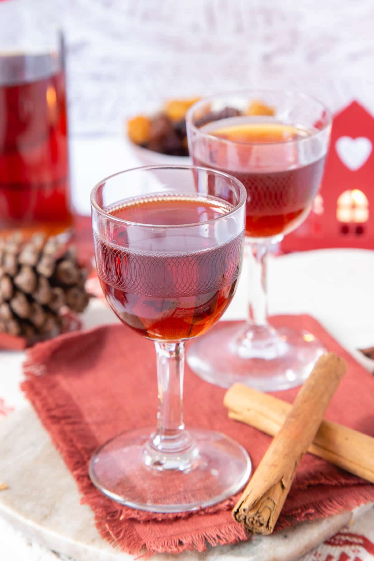 The warm, rich colour of this Christmas gin looks inviting against Scandinavian style Christmas decorations in red and white
