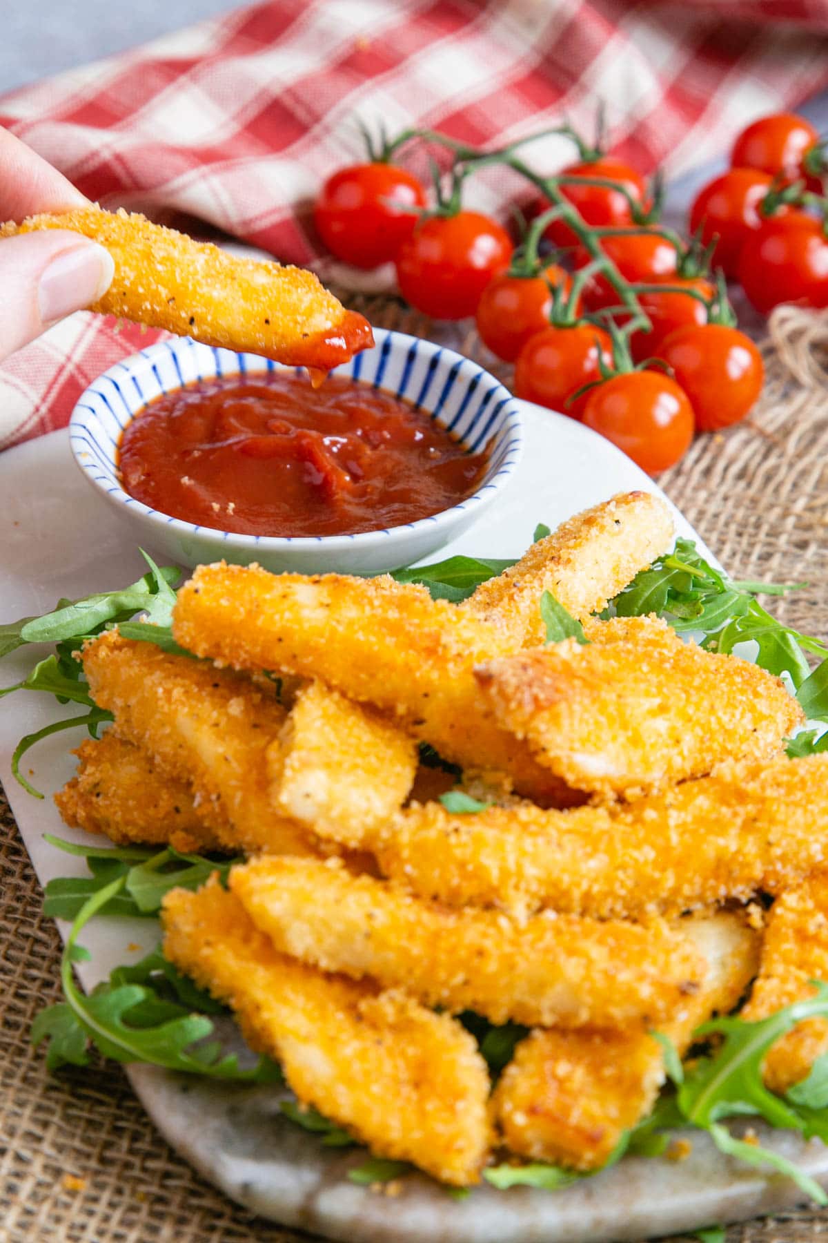 Dipping the first crunchy golden fry into a spicy tomato ketchup.