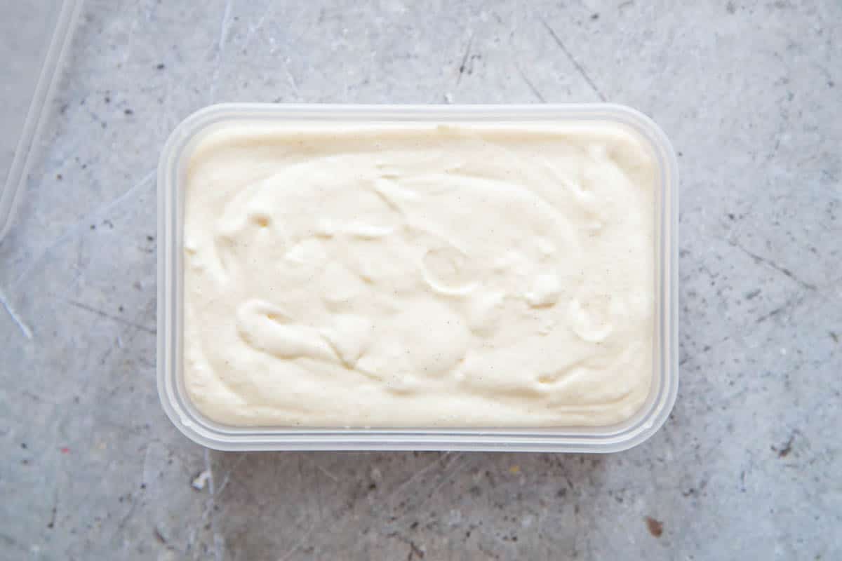 The ice cream mixture in a freezer-safe container, smoothed and ready to freeze.