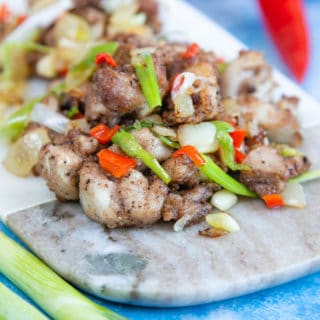 Bright and cheerful with red chilli and green onions, this salt and pepper chicken is a feast for the eyes as well.