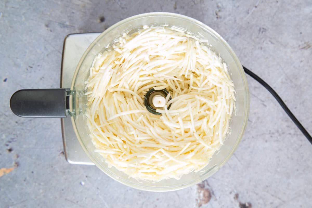 Grating the celeriac in a food processor produces a finer shred than cutting by hand and saves time.