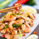 Digging into delicious salt and pepper prawns with chopsticks