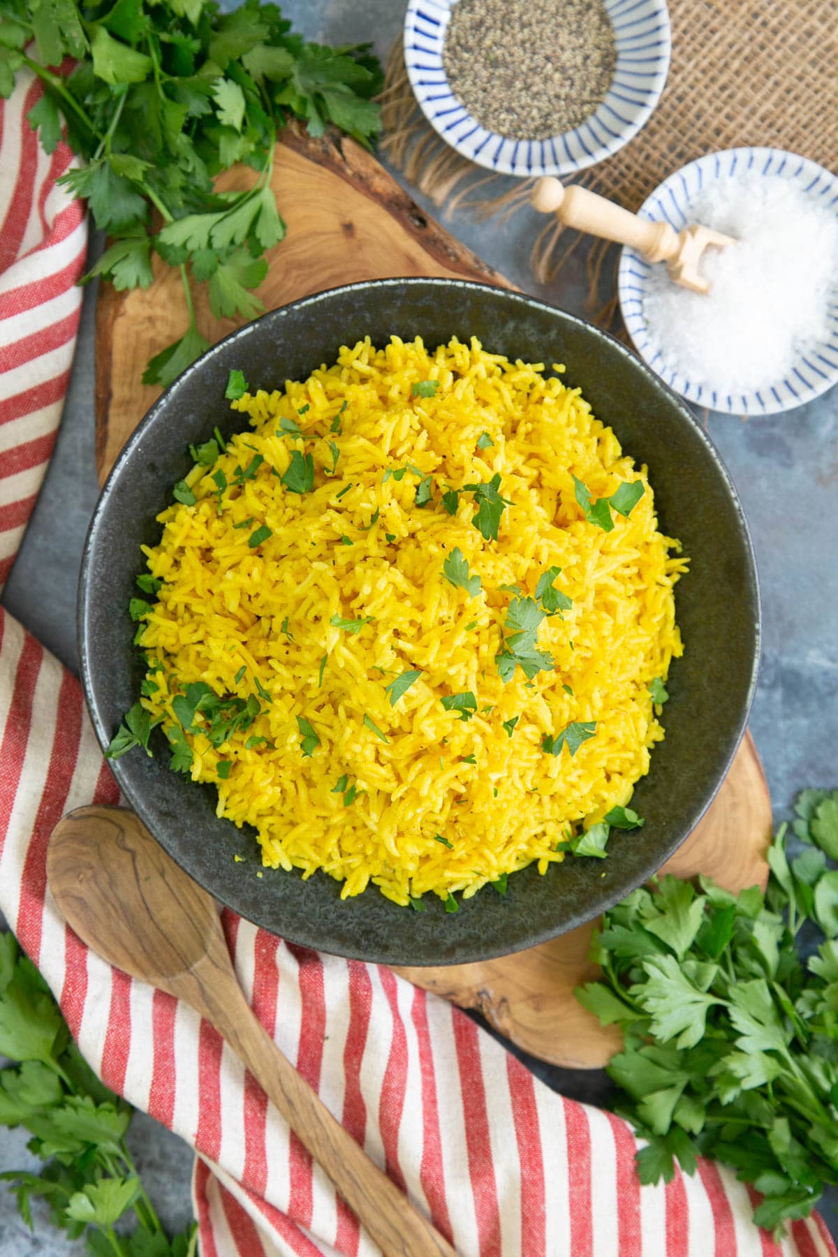 Turmeric rice makes a bright and cheerful addition to table laid with a colourful red and white cloth.