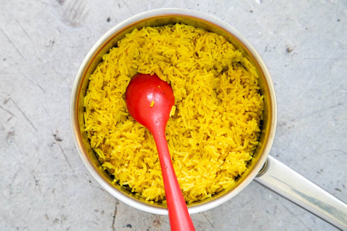 Once your golden rice is cooked and rested, it can be fluffed up ready to serve.