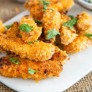 Crispy, crunchy, baked chicken goujons, scattered with a little parsley to serve.