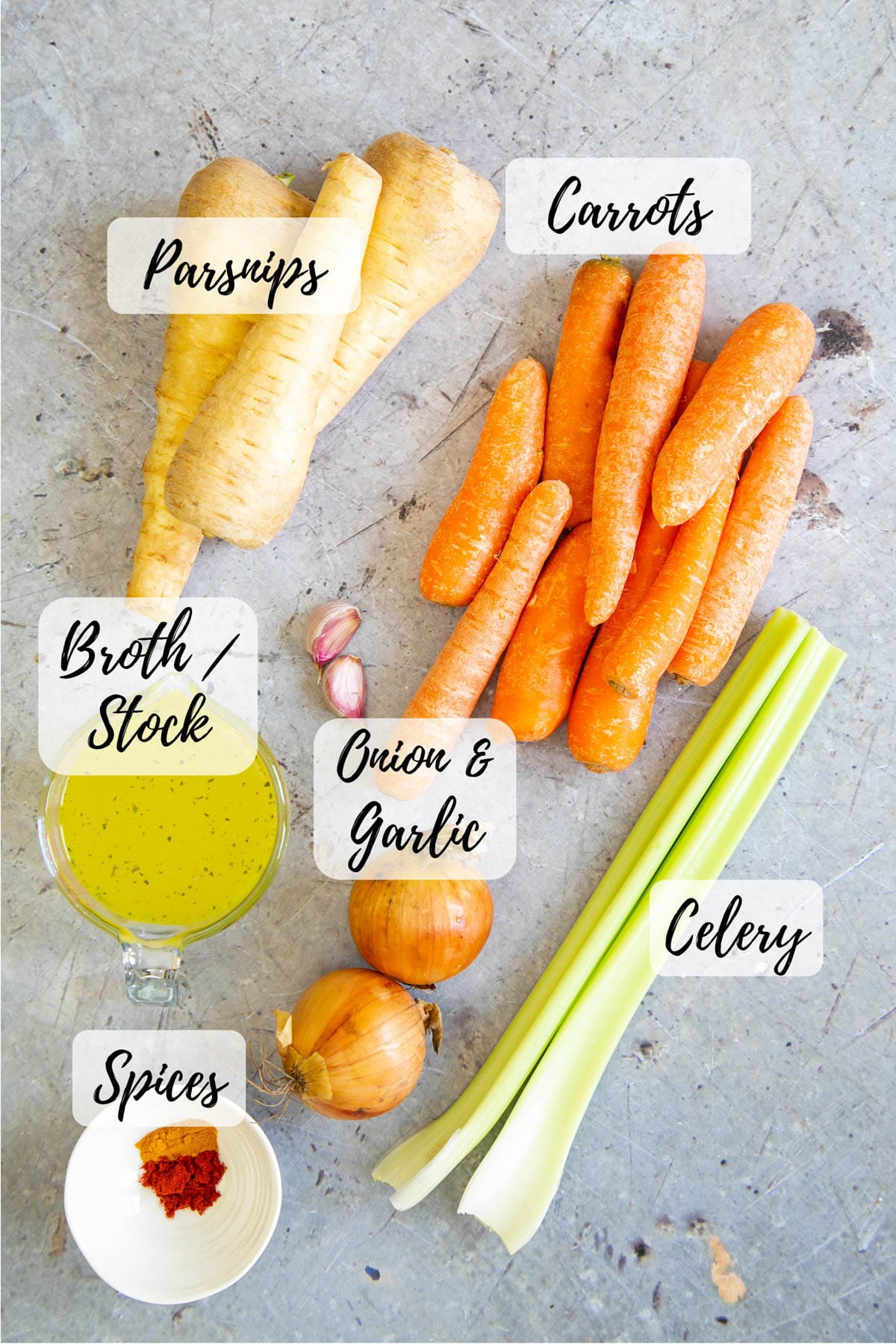 Ingredients for carrot and parsnip soup: parsnips, carrots, celery, onion and garlic, spices, stock