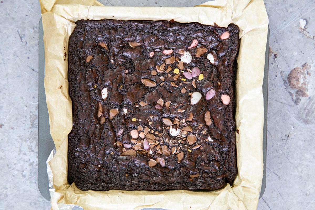 When baked, the brownies have a papery crust and wrinkle at the edges of the pan. There should still be a wobble to the centre.