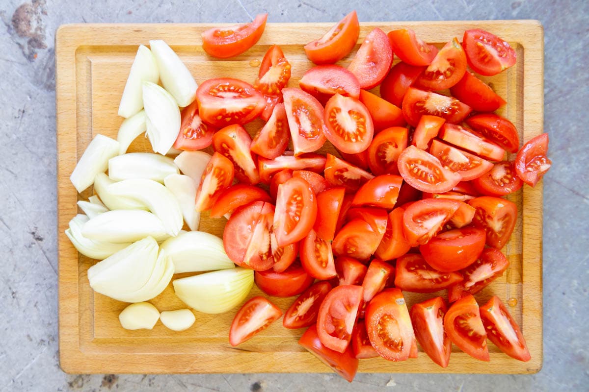 The tomatoes, onions and garlic are roughly chopped, ready to cook.