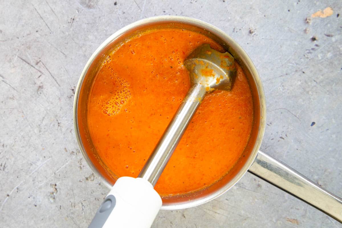 Once cooked and slightly cooled, the soup has been blended with a stick blender for a smooth orange soup.
