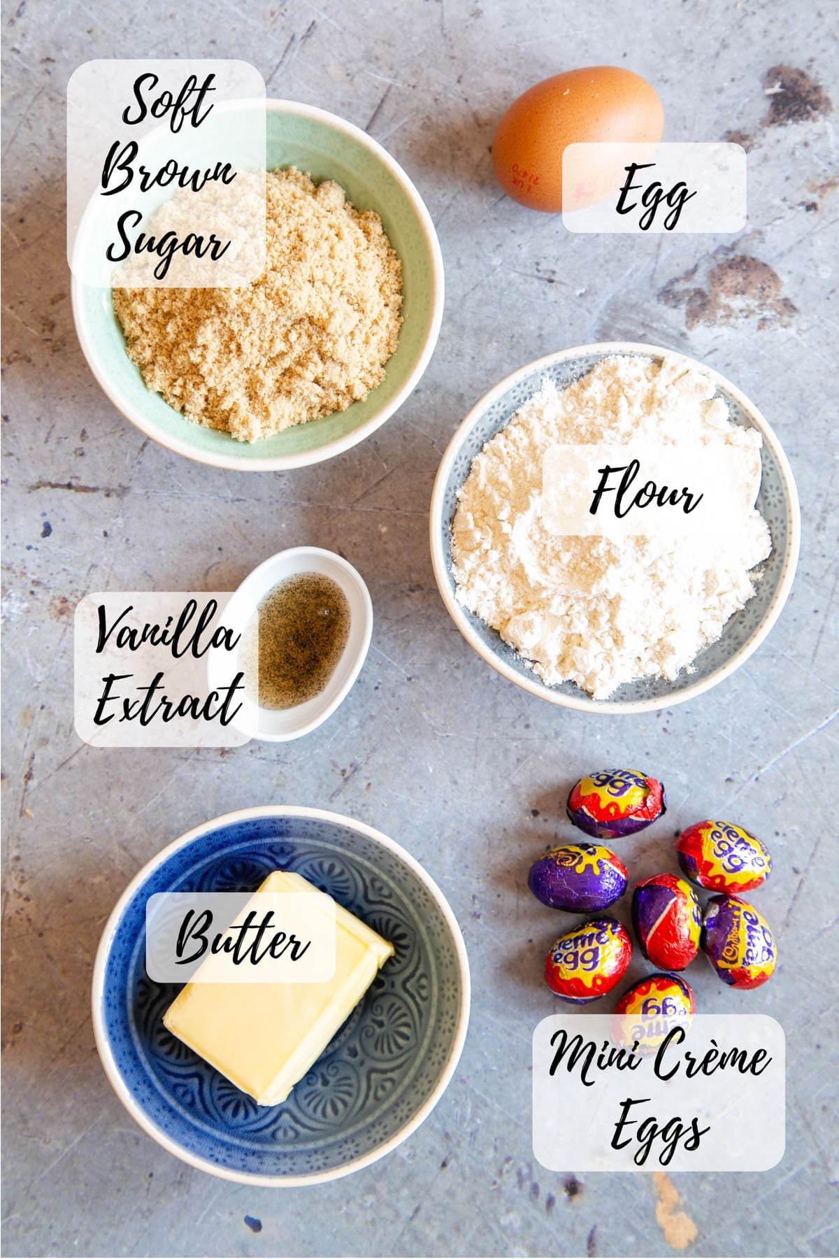 Ingredients for creme egg blondies: egg, flour, mini creme eggs, butter, vanilla extract, soft brown sugar