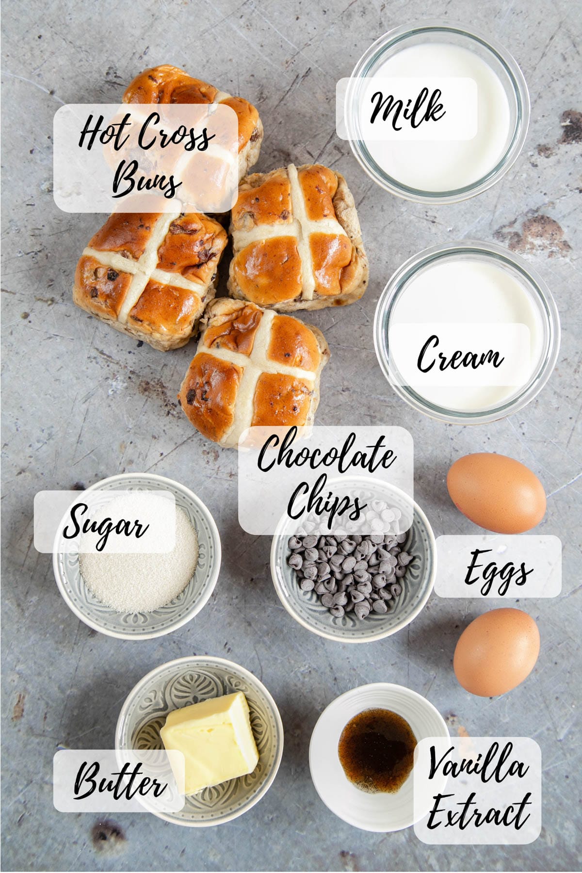 The ingredients assembled, ready to cook: hot cross buns, milk, cream, eggs, vanilla extract, butter, sugar and chocolate chips